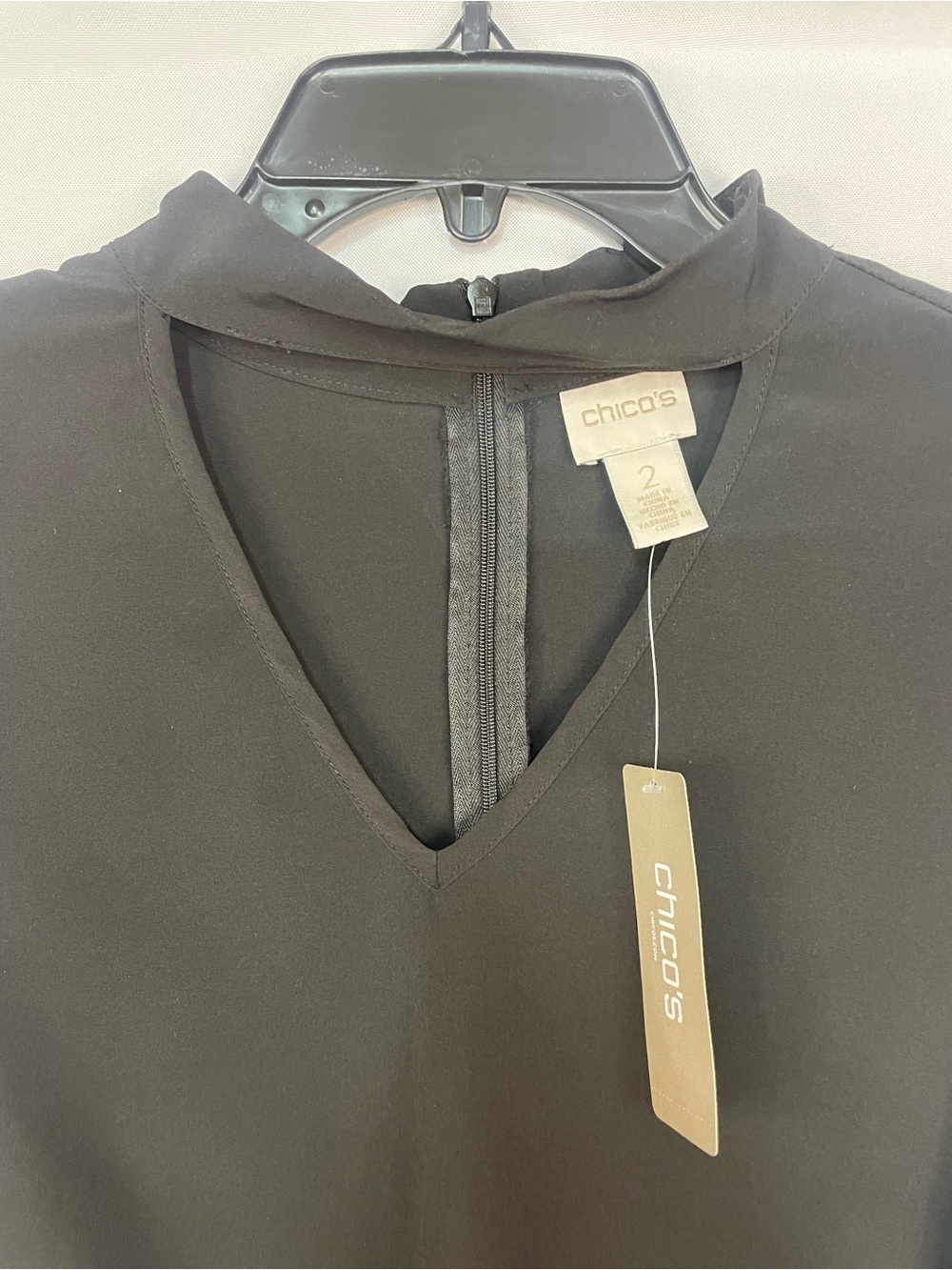 NWT Chicos black blouse with a cutout neck line and gold accents. Size 2 - Picture 5 of 7